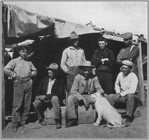Fig. 43.: American Museum party at Bone-Cabin Quarry,
1899. Seated, left to right Walter Granger, Professor H.F. Osborn, Dr.
W.D. Matthew; standing, F. Schneider, Prof. R.S. Lull, Albert Thomson,
Peter Kaison.